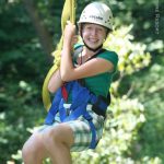 Young canopy-tour enthusiast on zip line, ACE Adventure Resort