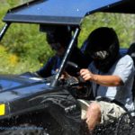ATV driving through mud at Burning Rock Outdoor Adventure Park