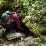 A caver explores at vent at Ice Mountain in Hampshire County, West Virginia (WV).