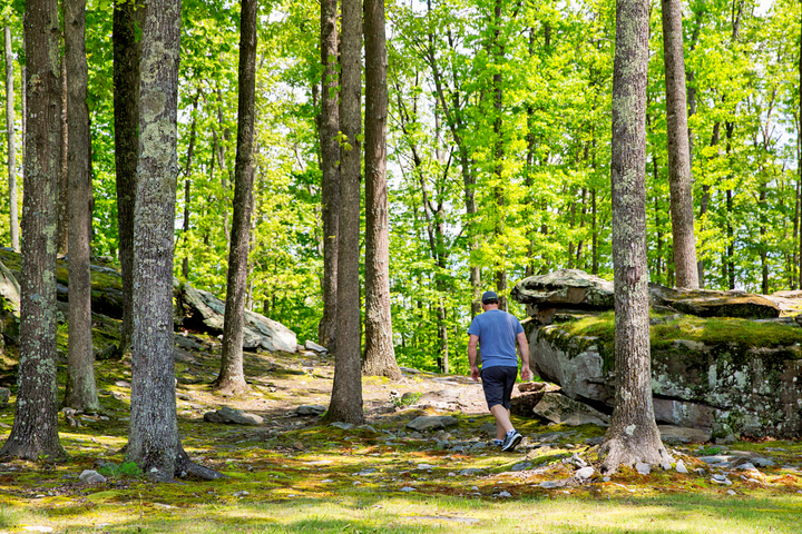 Hiker wanders among rocks near River Expeditions