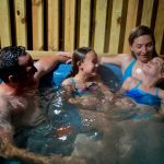 Family relaxes in private hot tub, River Expeditions