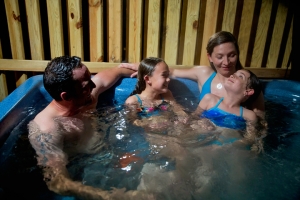 Family relaxes in private hot tub, River Expeditions