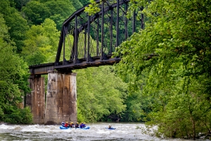 Rafters paddle beneath historic New River railroad trestle