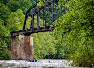 Rafters paddle beneath historic New River railroad trestle
