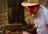 David Sibray examines a Washington family headstone near the mouth of Hurricane Creek in Putnam County, West Virginia.