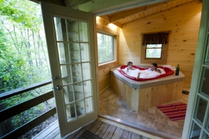 A couple soaks in a vintage hear-shaped tub at Country Road Cabins