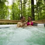 Couple in hot tub at Country Road Cabins