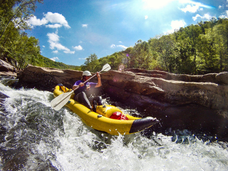A paddler in an inflatable kayak challenges the Dries of the New River.