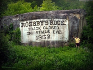 Sibray stands alongside Rosby's Rock, Marshall County