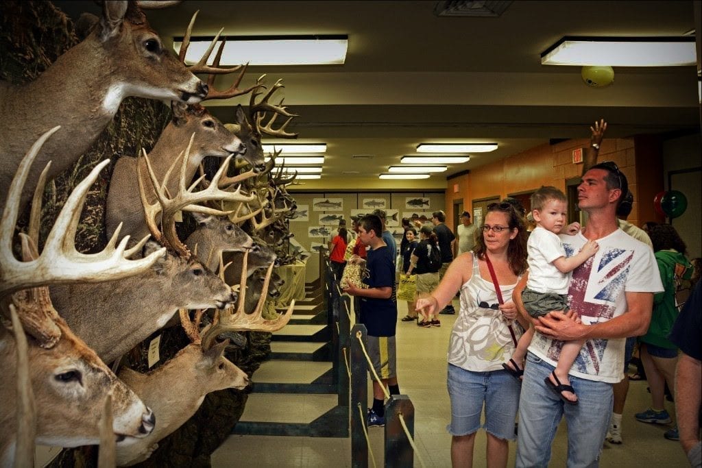 A family visits the National Hunting and Fishing Day display in West Virginia.