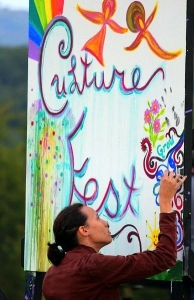 A festival-goer paints a community art board at the annual Culturefest festival at Pipestem, West Virginia.