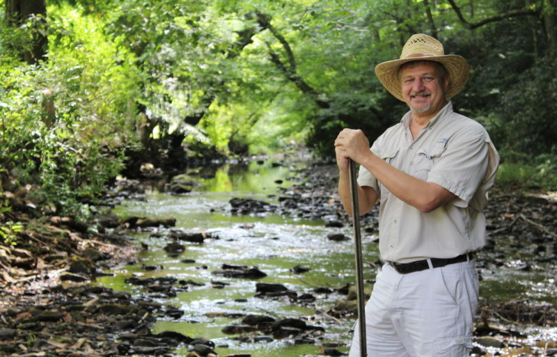 David Sibray pauses along a mountain stream in West Virginia, the landscape he's been promoting professionally for 30 years.