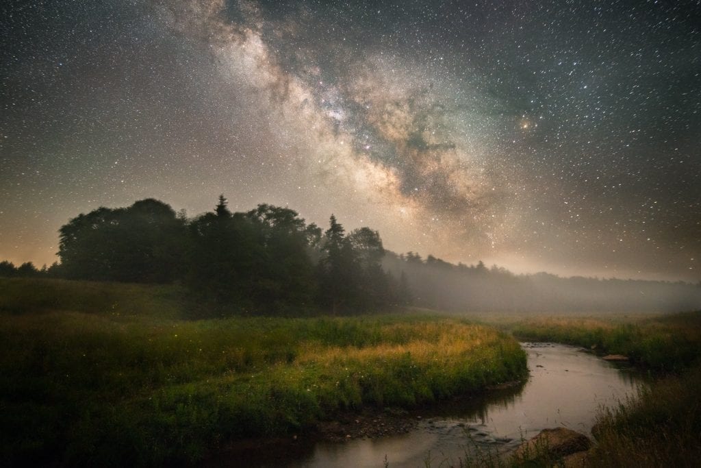 The Milky Way rises out of a mist on Gandy Creek.