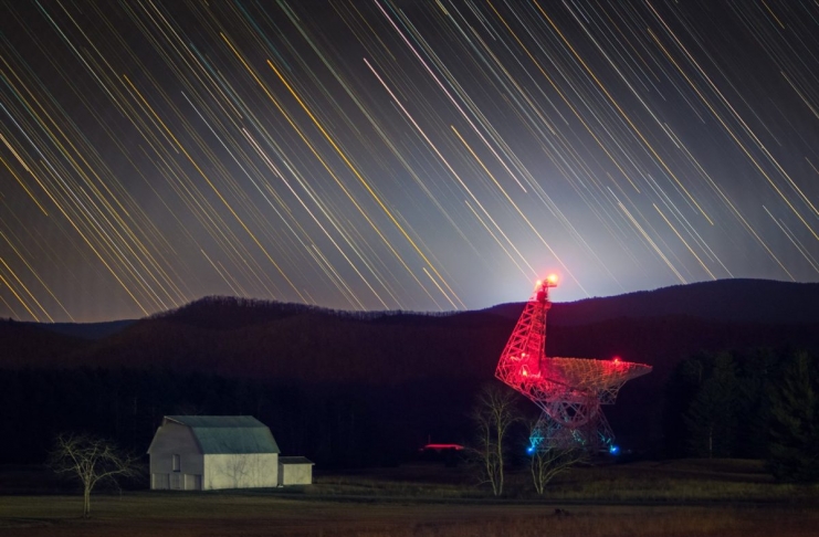 The Byrd Telescope glows red in the darkness at Green Bank.