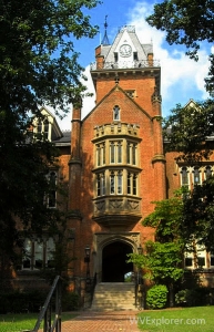 Old Main's iconic tower rises behind the building's central entrance.