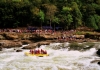 Rafters outfitted with River Expeditions watch raft-load plow through Sweets Falls on the Gauley River.