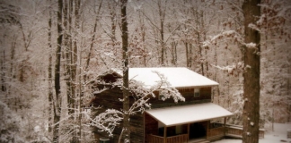 A cabin at River Expeditions awaits guests beneath a blanket of new-fallen snow.