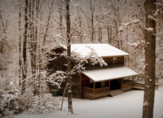 A cabin at River Expeditions awaits guests beneath a blanket of new-fallen snow.