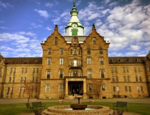 Dwarfed by its massive tower, hosts flanking the front door welcome guests to the Trans-Allegheny Lunatic Asylum.