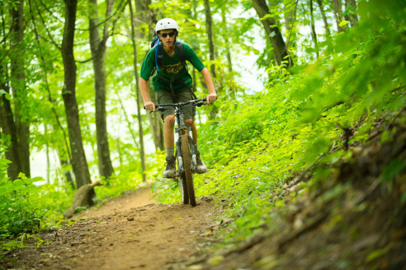 A mountain biker explores trails at the Summit Bechtel Scout Reserve near the New River Gorge.
