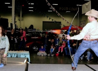 Frank Addington, Jr., takes aim at aspirin at the W.Va. Hunting and Fishing Show.