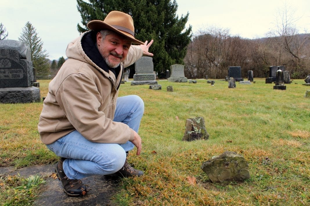David Sibray points toward the possible site of a prehistoric ruin in the old Mount Hope Cemetery.