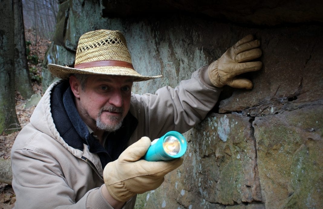 David Sibray peers into a cave system in southern West Virginia.