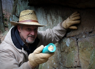 David Sibray peers into a cave system in southern West Virginia.