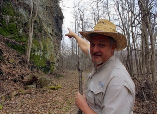 David Sibray points to the profile of President William McKinley, blasted into a cliff near Thurmond in 1901.