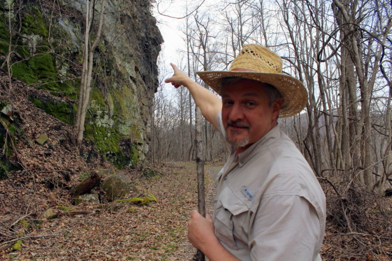 David Sibray points to the profile of President William McKinley, blasted into a cliff near Thurmond in 1901.