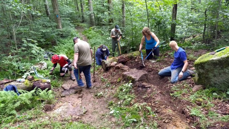 Volunteers with the New River Gorge Trail Alliance repair trail in the Monongahela National Forest with forest service staff and Youth Conservation Corp members.