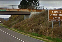 A sign recognizing the Eastern Continental Divide rises along I-68 in Maryland. Google Maps image.