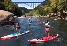 Racers on stand-up paddleboards ply the New River near Fayetteville, West Virginia. Photo courtesy Active SWV.