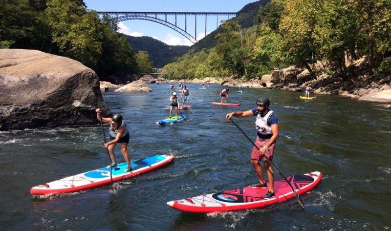 Racers on stand-up paddleboards ply the New River near Fayetteville, West Virginia. Photo courtesy Active SWV.
