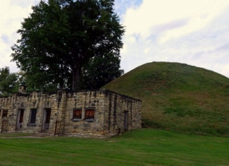 The Grave Creek Mound rises behind an early visitor center. Photo courtesy Charity Moore.