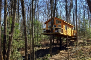 The Tuscany Treehouse looks out over the Meadow River woodlands at Country Road Cabins.