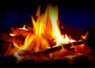 A campfire blazes in the West Virginia hills.