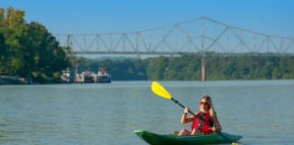 A kayaker plies the gentle Ohio River near Parkersburg, West Virginia, once the site of the infamous Graveyard of the Ohio.