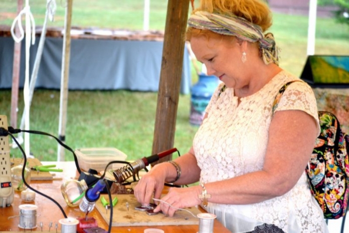 Mountain State Art and Craft Fair An artisan cuts stained glass at the Mountain State Art and Craft Fair at Ripley, West Virginia.