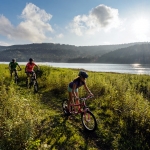 Bikers ride along Shavers Lake