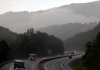 Motorists navigate the West Virginia Turnpike in Fayette County during a summer downpour.