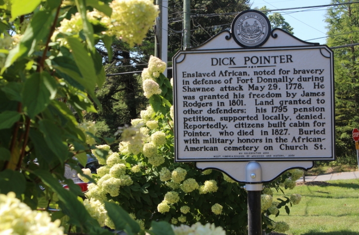 A historic marker recounting a version of the Dick Pointer tale stands near his monument.
