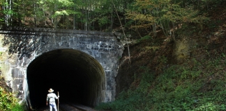 David Sibray peers into the Jenny Gap Tunnel near Lester, West Virginia, in Raleigh County.