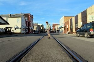 David Sibray stands warily between the rails that course through the center of Second Street in Saint Marys, West Virginia.