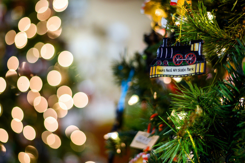 A Hawks Nest State Park ornament hangs on a Christmas tree.