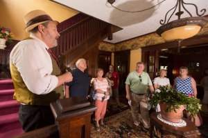 A Bramwell homeowner recounts the history of his house during the annual Christmas Tour of Homes at Bramwell, West Virginia.