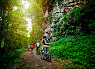 A family bikes a park trail in the New River Gorge National Park and Preserve.