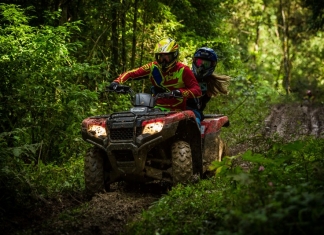 ATV riders navigate a muddy trail in the mountains of southern West Virginia.