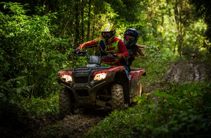 ATV riders navigate a muddy trail in the mountains of southern West Virginia.