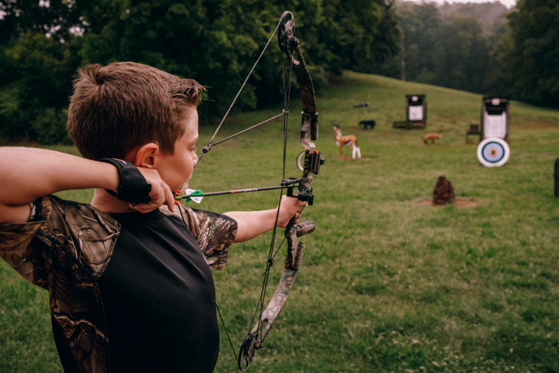A West Virginia youth practices target shooting with bow and arrow. (Photo courtesy W.Va. Dept. of Commerce)